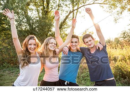 Portrait of group of friends in rural environment, arms raised, smiling View Large Photo Image Stock Photo - Portrait of group of friends in rural environment, arms raised, smiling. Fotosearch