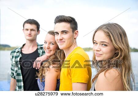 Stock Photo - Portrait of group of friends, outdoors, smiling. Fotosearch
