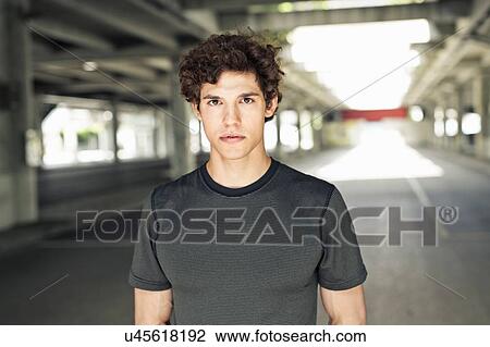 Portrait of serious young man in city underpass View Large Photo Image Stock Image - Portrait of serious young man in city underpass. Fotosearch