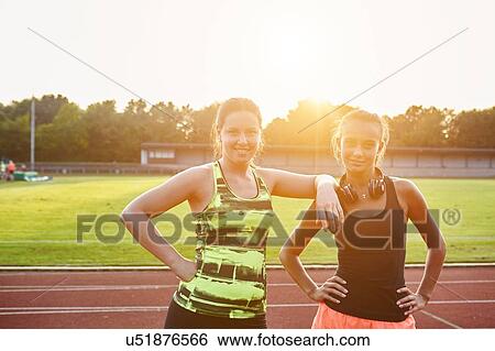 Portrait of two young female runners on race track View Large Photo Image Stock Photograph - Portrait of two young female runners on race track. Fotosearch