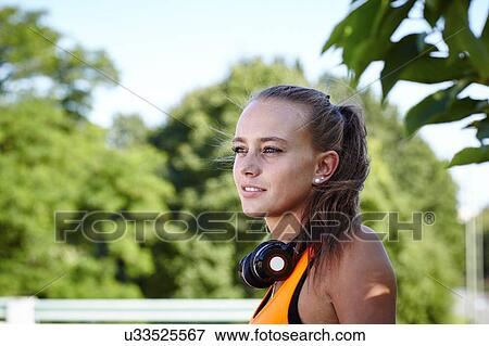 Portrait of young female runner looking away View Large Photo Image Stock Photo - Portrait of young female runner looking away. Fotosearch