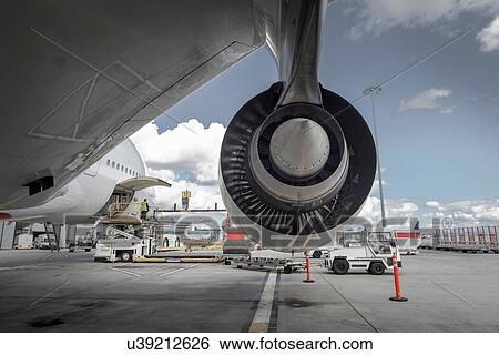 Rear view of A380 jet engine with ground crew loading freight View Large Photo Image Stock Photograph - Rear view of A380 jet engine with ground crew loading freight. Fotosearch