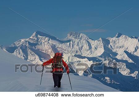 Stock Photo - Rear view of climber moving up through deep snow, Swiss Alps, Canton Wallis, Switzerland. Fotosearch