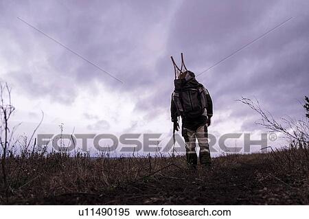Stock Photography - Rear view of male hiker hiking in empty landscape, Ural, Russia. Fotosearch