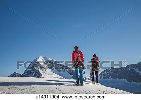 Rear view of two male climbers moving up, Canton Bern, Switzerland View Large Photo Image Picture - Rear view of two male climbers moving up, Canton Bern, Switzerland. Fotosearch