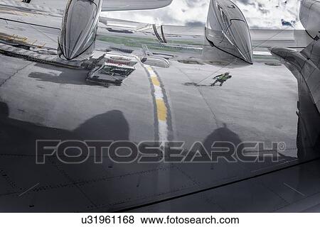 Reflection of ground crew in wing of A380 aircraft View Large Photo Image Stock Photo - Reflection of ground crew in wing of A380 aircraft. Fotosearch