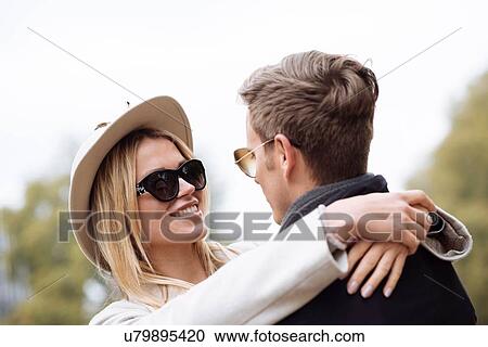 Stock Image - Romantic couple hugging in park. Fotosearch