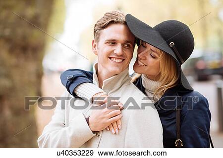 Stock Photo - Romantic young couple in park, London, England, UK. Fotosearch