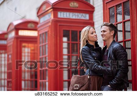 Romantic young couple next to red phone boxes, London, England, UK View Large Photo Image Stock Image - Romantic young couple next to red phone boxes, London, England, UK. Fotosearch