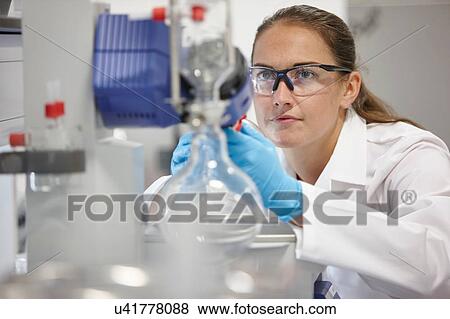 Stock Photo - Scientist using rotary evaporator in laboratory. Fotosearch