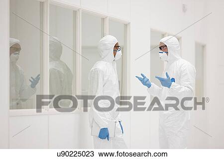 Stock Image - Scientists talking in laboratory. Fotosearch