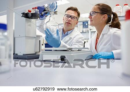 Stock Photo - Scientists using rotary evaporator in laboratory. Fotosearch