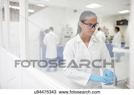 Stock Image - Scientists working in laboratory. Fotosearch