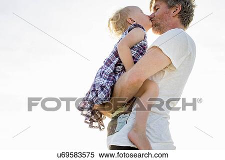 Side view of female toddler and father kissing View Large Photo Image Stock Photography - Side view of female toddler and father kissing. Fotosearch