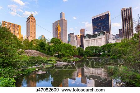 Skyline in reflection lake in Central Park, New York, USA View Large Photo Image Stock Photo - Skyline in reflection lake in Central Park, New York, USA. Fotosearch