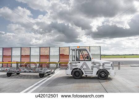 Small baggage handling tug at airport View Large Photo Image Stock Image - Small baggage handling tug at airport. Fotosearch