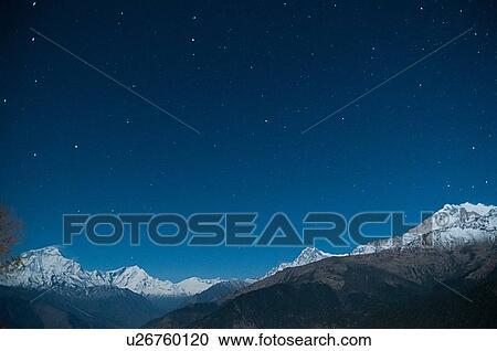 Snow capped mountain range under starry night sky, Nepal View Large Photo Image Stock Image - Snow capped mountain range under starry night sky, Nepal. Fotosearch