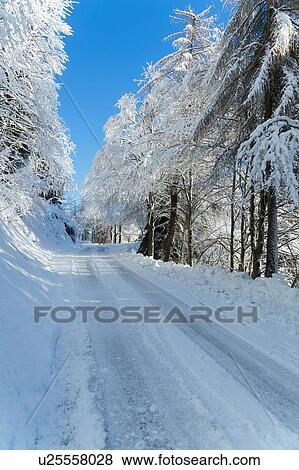 Stock Photo - Snow covered rural road, Monte Rosa, Piedmont, Italy. Fotosearch