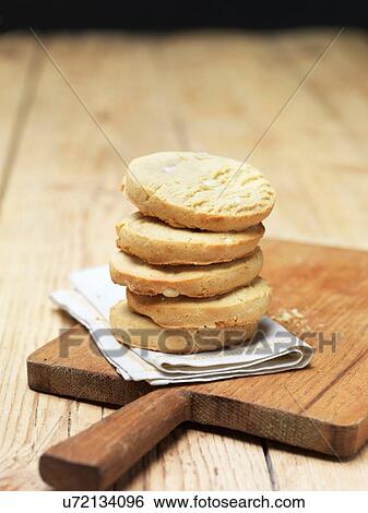 Stock Photograph - Stack of lemon meringue cookies on tea towel. Fotosearch