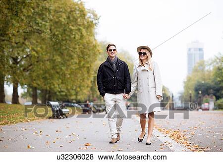 Stock Photo - Stylish young couple strolling in park, London, England, UK. Fotosearch