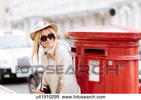 Stylish young woman waiting by red post box, London, England, UK View Large Photo Image Stock Photo - Stylish young woman waiting by red post box, London, England, UK. Fotosearch