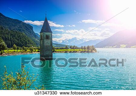 Sunlit church spire in lake, Trentino Alto Adige, Italy View Large Photo Image Stock Image - Sunlit church spire in lake, Trentino Alto Adige, Italy. Fotosearch