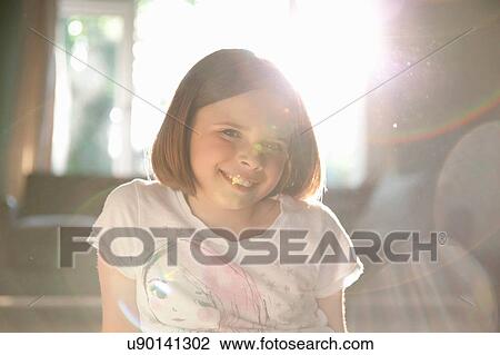 Sunlit illuminated portrait of smiling girl View Large Photo Image Stock Image - Sunlit illuminated portrait of smiling girl. Fotosearch