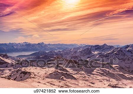 Stock Image - Sunset over snow covered mountains, Cervinia, Italy. Fotosearch
