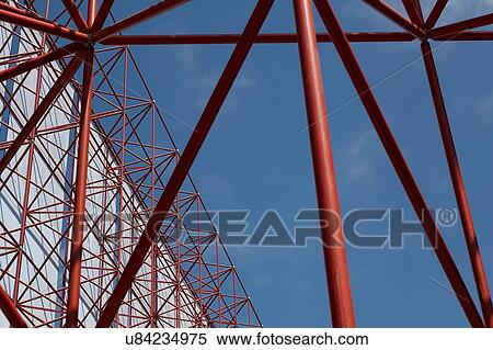 Stock Photography - Tall red framework structure with textile against blue sky. Fotosearch