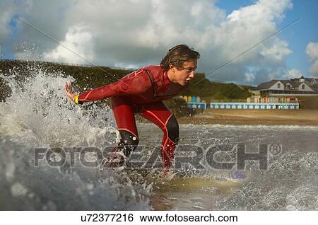 Teenage boy, surfing View Large Photo Image Stock Photograph - Teenage boy, surfing. Fotosearch