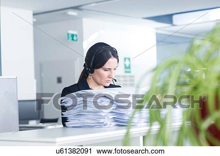 Telephonist working in office View Large Photo Image Stock Image - Telephonist working in office. Fotosearch