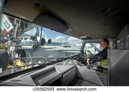 Tug driver towing A380 aircraft View Large Photo Image Stock Image - Tug driver towing A380 aircraft. Fotosearch