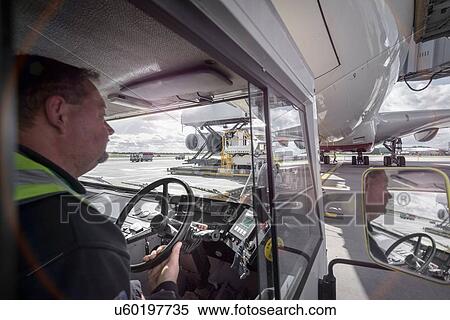 Stock Photography - Tug driver towing A380 aircraft. Fotosearch