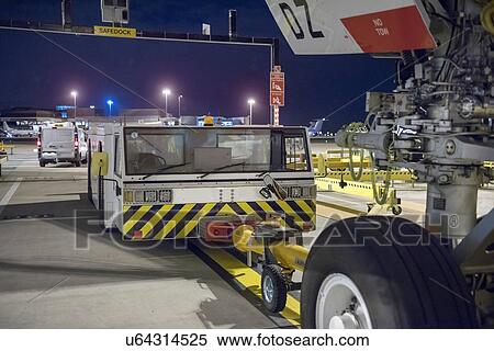 Tug for towing A380 aircraft on runway at night View Large Photo Image Stock Photography - Tug for towing A380 aircraft on runway at night. Fotosearch