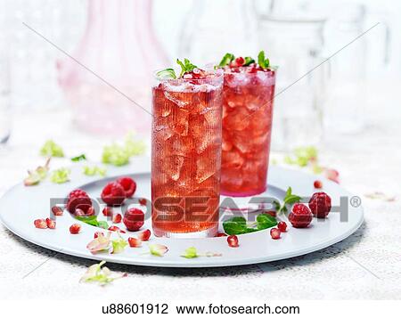 Two glasses of port punch with ice, fresh raspberries and pomegranate View Large Photo Image Stock Image - Two glasses of port punch with ice, fresh raspberries and pomegranate. Fotosearch