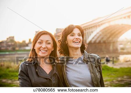 Two mid adult women smiling, portrait View Large Photo Image Stock Photography - Two mid adult women smiling, portrait. Fotosearch