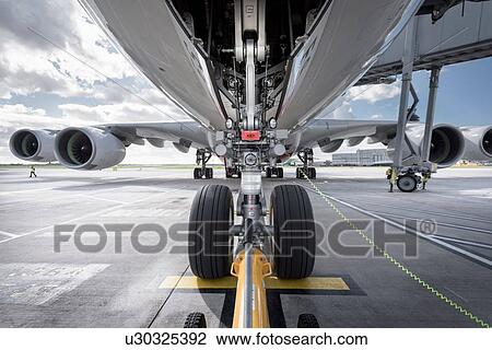 Stock Image - Underside view of A380 aircraft about to taxi. Fotosearch