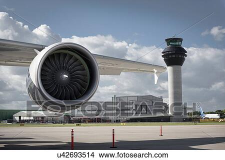 View of A380 jet engine and control tower at airport View Large Photo Image Picture - View of A380 jet engine and control tower at airport. Fotosearch