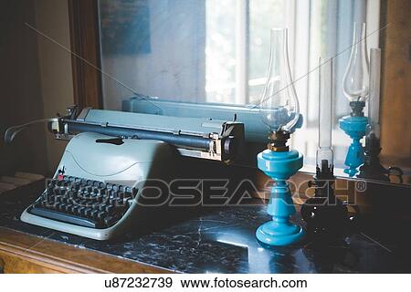 Vintage typewriter and oil lamps on table View Large Photo Image Stock Photo - Vintage typewriter and oil lamps on table. Fotosearch