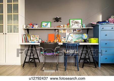 Violin, globe, paintings and books on childs desk and shelves View Large Photo Image Stock Photo - Violin, globe, paintings and books on childs desk and shelves. Fotosearch