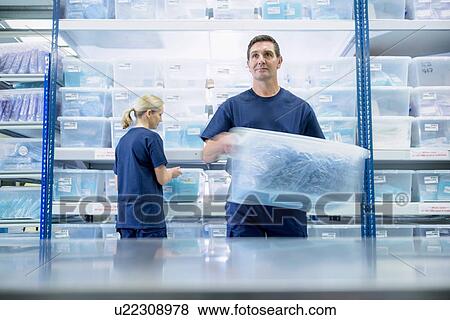 Warehouse workers in surgical instrument factory View Large Photo Image Stock Photo - Warehouse workers in surgical instrument factory. Fotosearch