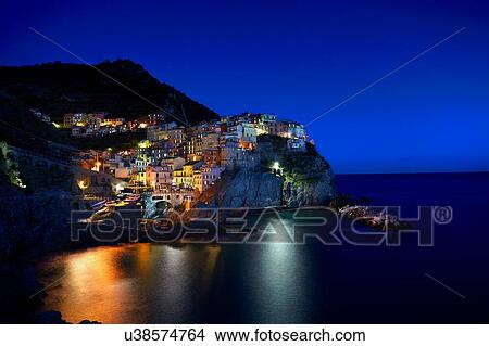 Waterfront cliff town of Manorola at night, Italy View Large Photo Image Picture - Waterfront cliff town of Manorola at night, Italy. Fotosearch