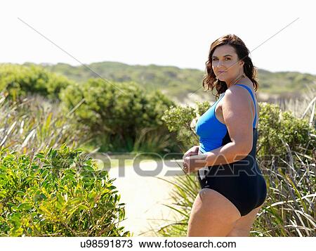 Stock Image - Woman in swimsuit on beach, Point Impossible, Victoria, Australia. Fotosearch