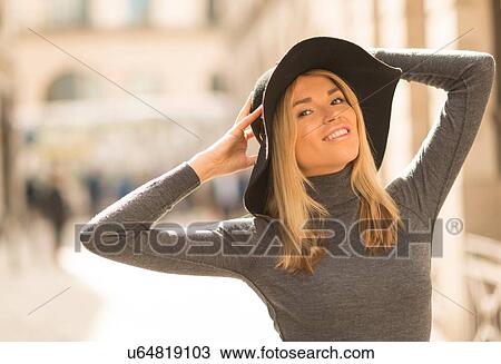 Stock Image - Woman posing in street. Fotosearch