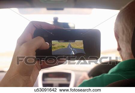 Womans hand in car photographing diminishing perspective of rural road, Cumbria, UK View Large Photo Image Stock Image - Womans hand in car photographing diminishing perspective of rural road, Cumbria, UK. Fotosearch