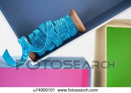 Wooden reel of sparkly blue ribbon in gift box View Large Photo Image Stock Image - Wooden reel of sparkly blue ribbon in gift box. Fotosearch