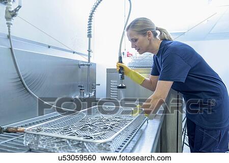 Worker cleaning surgical instruments in ultrasonic bath in surgical instrument factory View Large Photo Image Stock Image - Worker cleaning surgical instruments in ultrasonic bath in surgical instrument factory. Fotosearch
