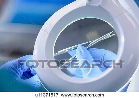 Worker inspecting surgical instruments in clean room of surgical instruments factory, close up View Large Photo Image Stock Photo - Worker inspecting surgical instruments in clean room of surgical instruments factory, close up. Fotosearch