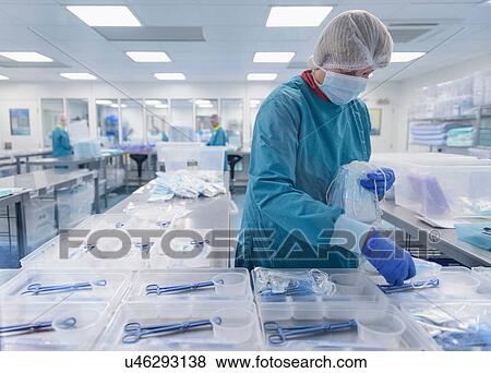 Stock Photo - Worker packing surgical instruments in clean room of surgical instruments factory. Fotosearch