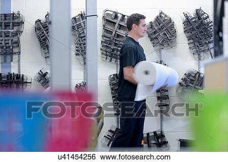 Worker passing fabric cutting tools on wall in factory View Large Photo Image Stock Photograph - Worker passing fabric cutting tools on wall in factory. Fotosearch